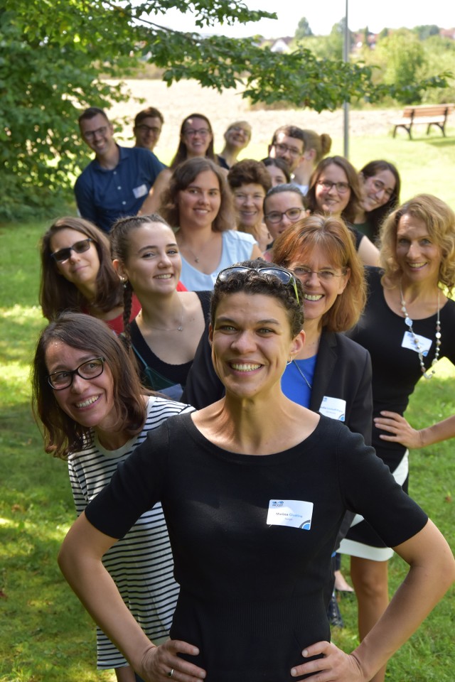 Group photo of event participants standing in a row.