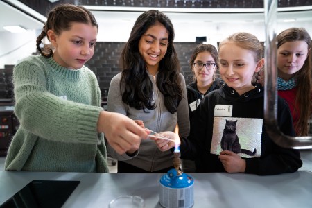 Girls experimenting with Physics demonstrations with curiosity. 