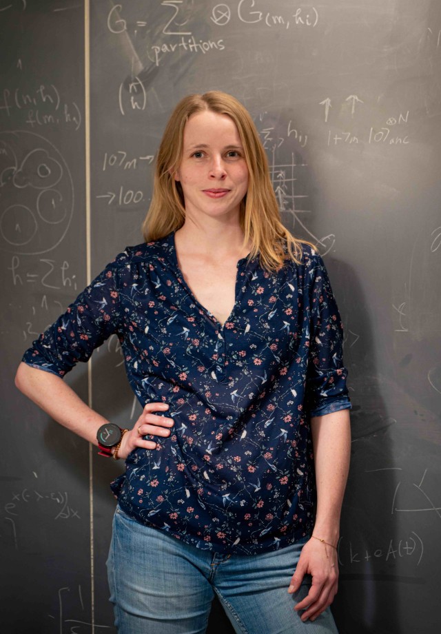 Annabelle Bohrdt standing in front of a blackboard with mathematical formulas.
