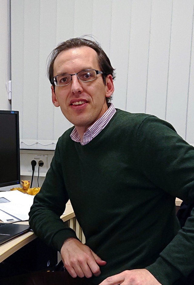 Frank Deppe standing at his desk in his office at WMI. 