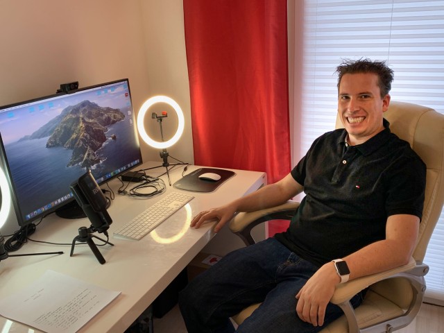 Kai Müller sitting at his desk working from home office. 
