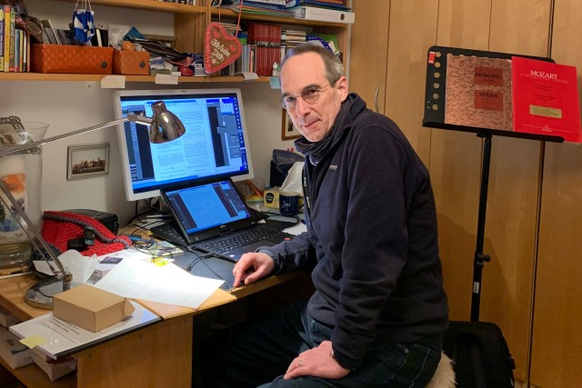 Jan von Delft sitting at his desk in front of a computer in his home office.