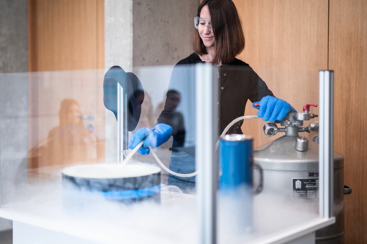 Female researcher preparing an experiment with liquid nitrogen.