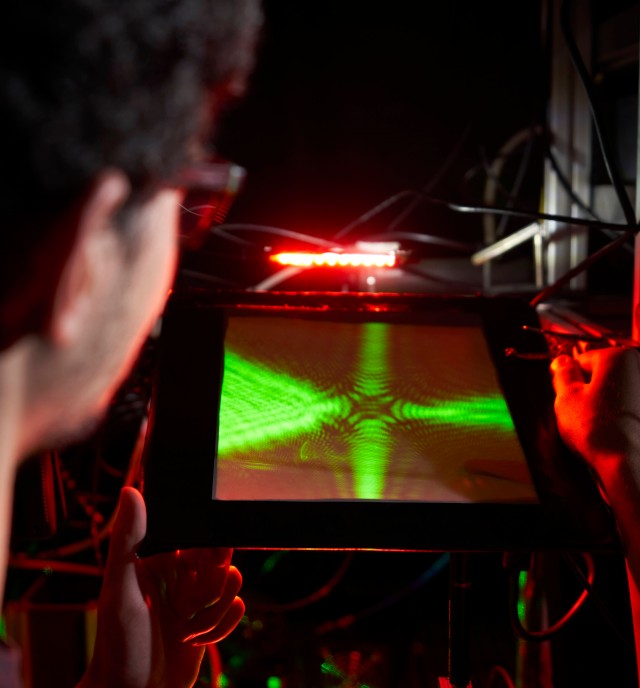 Close-up of a researcher looking at a confocal microscope picture of an experiment. 